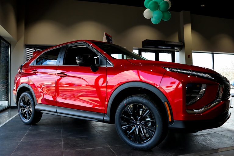 Vibrant red SUV showcased inside a showroom with sleek design and shiny finish.